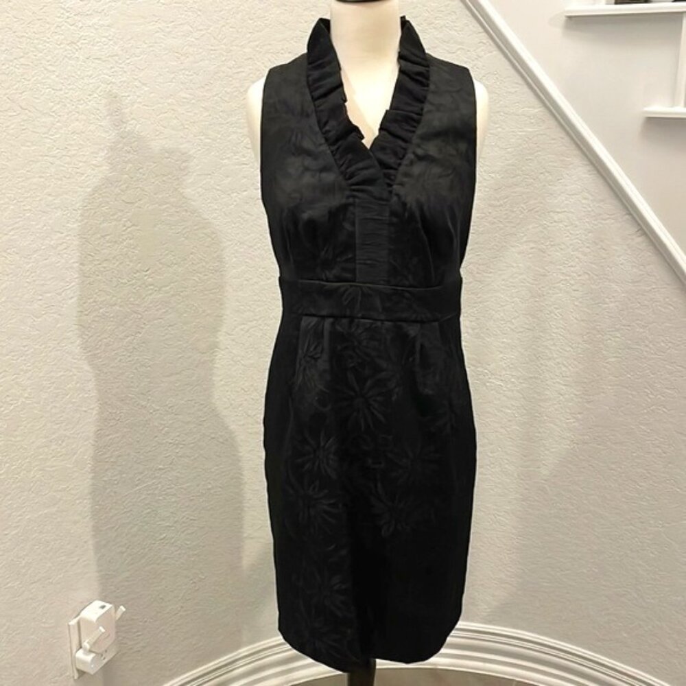 Elegant black on black sleeveless embossed dress w/ ruffle detail & side zipper.